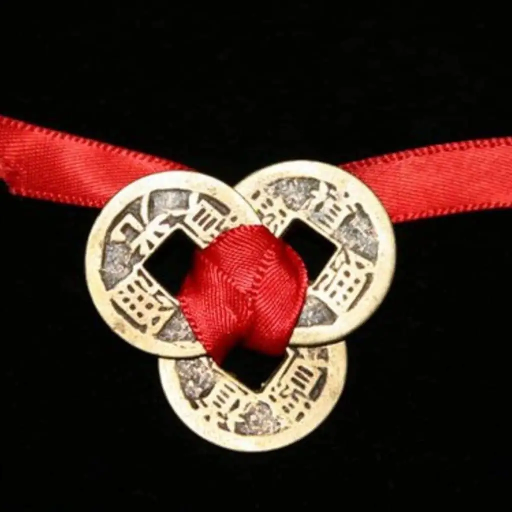 3 Feng shui coins bound with red ribbon