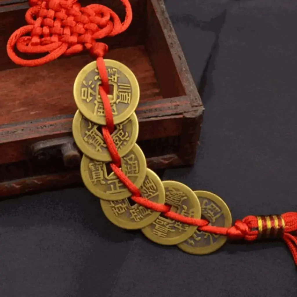 6 coins tied with red ribbon