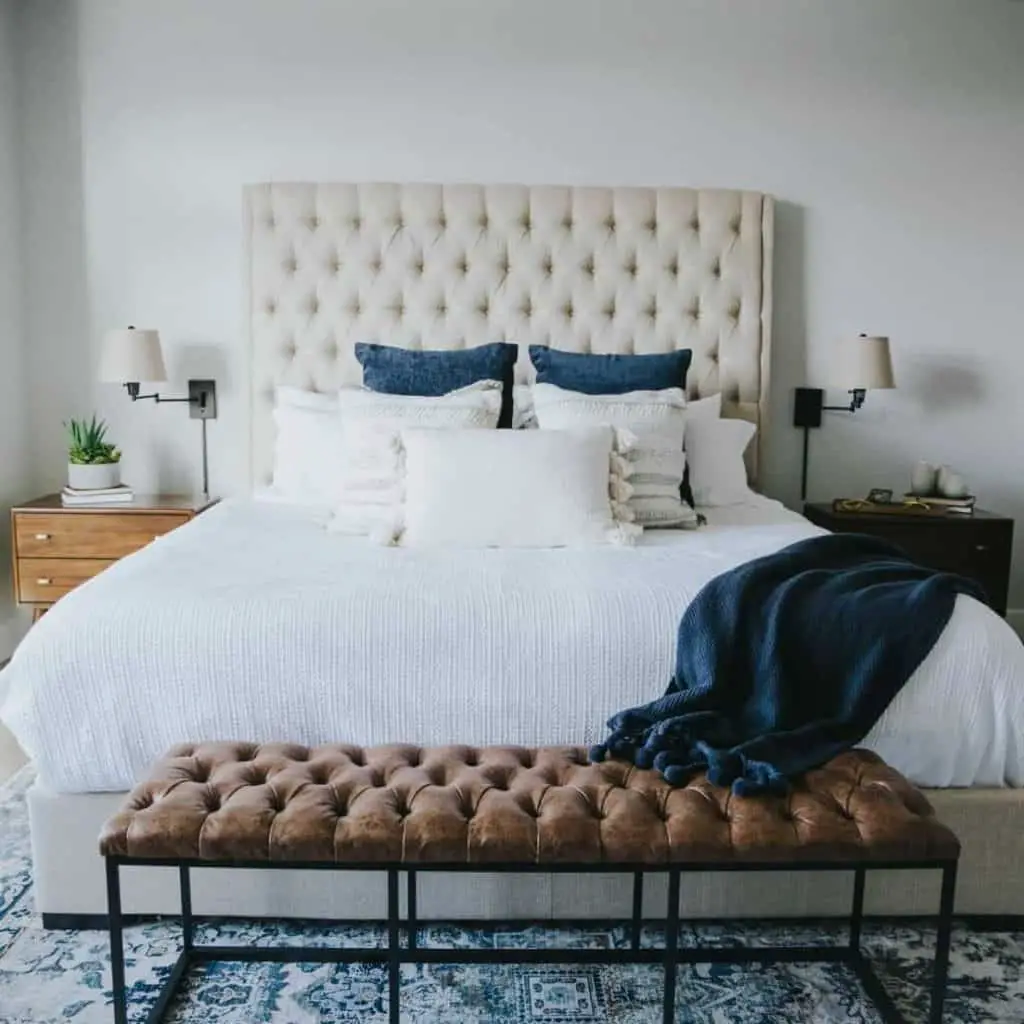 Dark blue highlights in a generally white and brown base bedroom